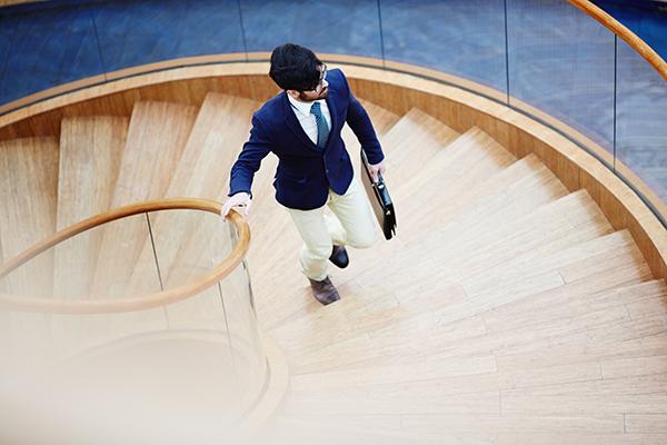 Man in suit going up the stairs