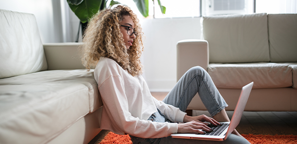 woman sitting on floor with laptop