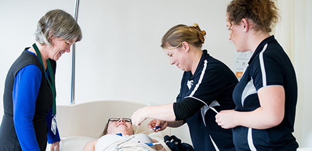 Nursing teacher advising students on procedures