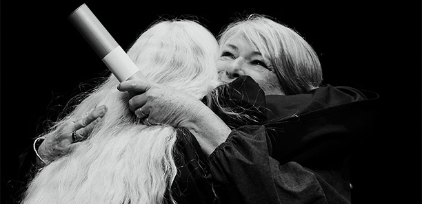 Leah Emmons hugging a student at graduation