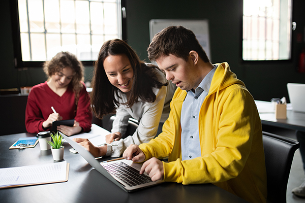 teacher's aide assisting student with disability