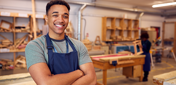 Portrait Of Male Student Studying For Carpentry Apprenticeship At College