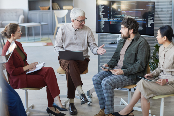 Senior man in meeting circle