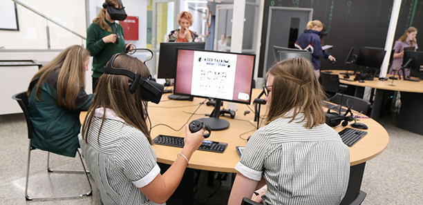 Sisters in high school studying STEM and using VR headset