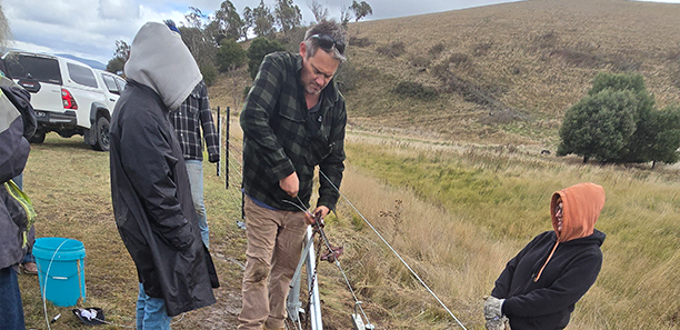 Fencing project participants at work